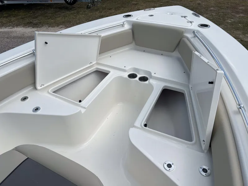 Slide: The Image of 2025 Key West 219 FS boat interior with open storage compartments and cup holders. - 11
