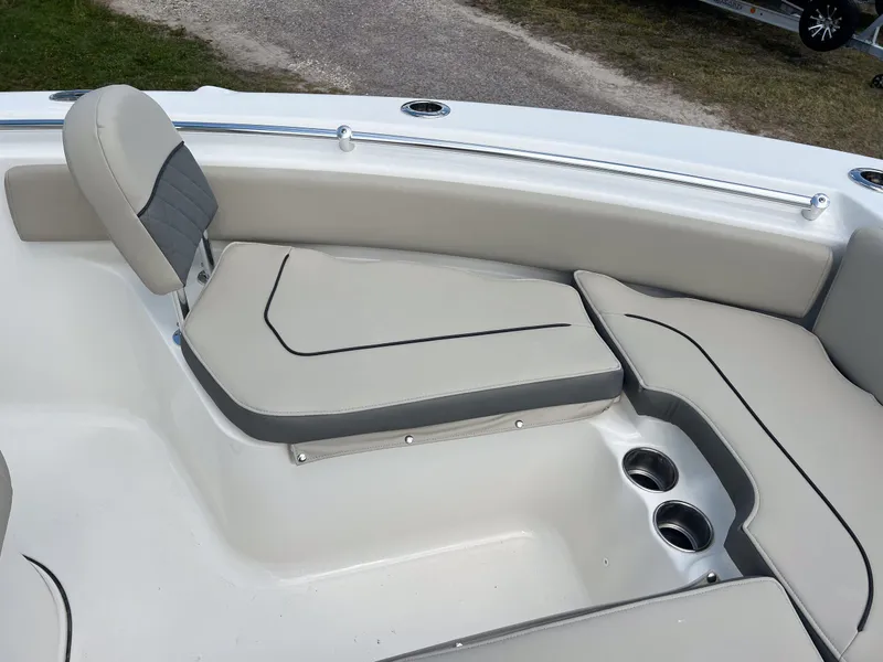 Slide: The Image of 2025 Key West 219 FS boat interior with cushioned seating and cup holders. - 15