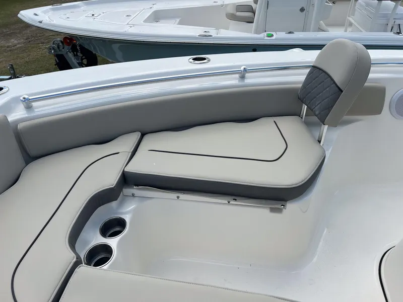 Slide: The Image of 2025 Key West 219 FS boat interior with cushioned seating and cup holders. - 17