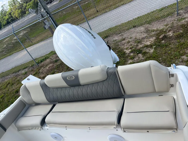 Slide: The Image of 2025 Key West 219 FS boat interior with cushioned seating and outboard motor. - 18