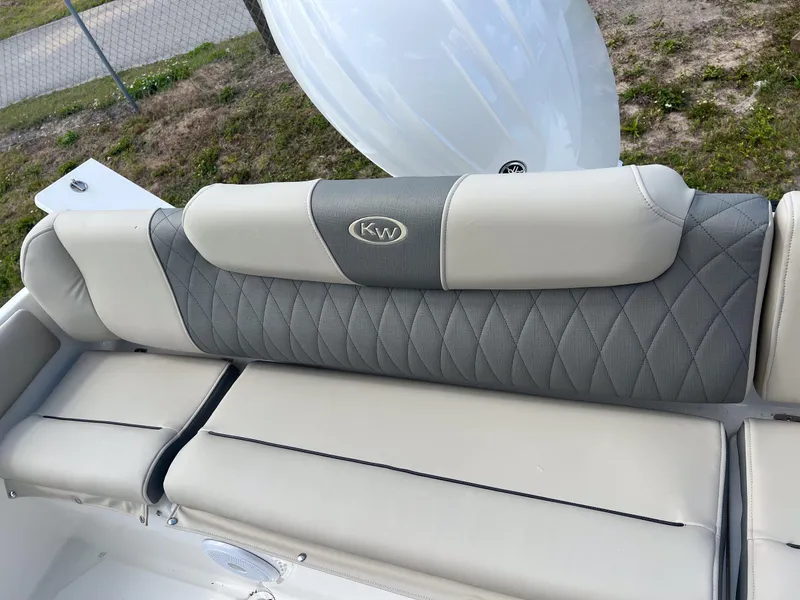 Slide: The Image of 2025 Key West 219 FS boat seat with gray and beige upholstery, featuring diamond stitching. - 19
