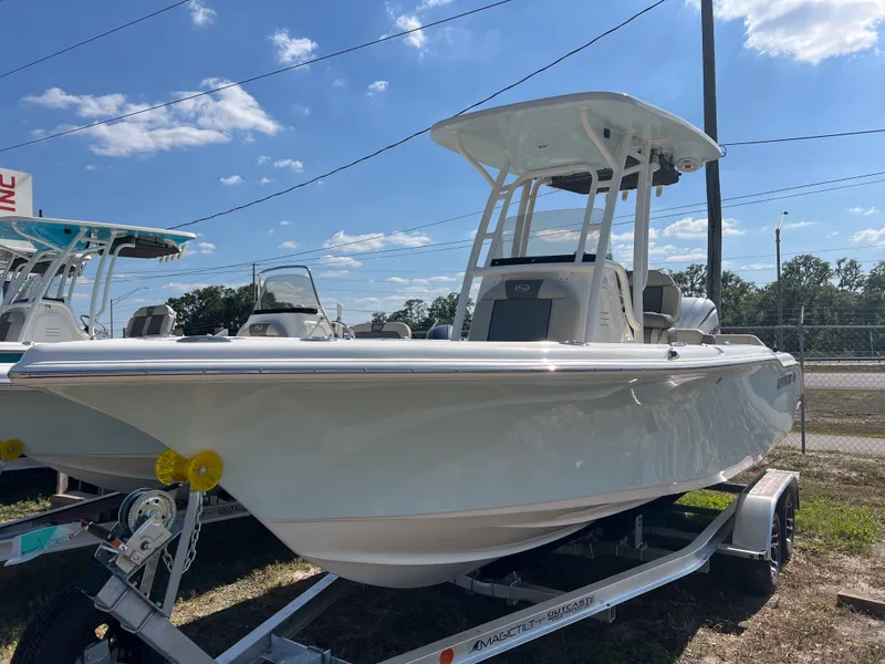Slide: The Image of 2025 Key West 219 FS boat on trailer under clear blue sky. - 9