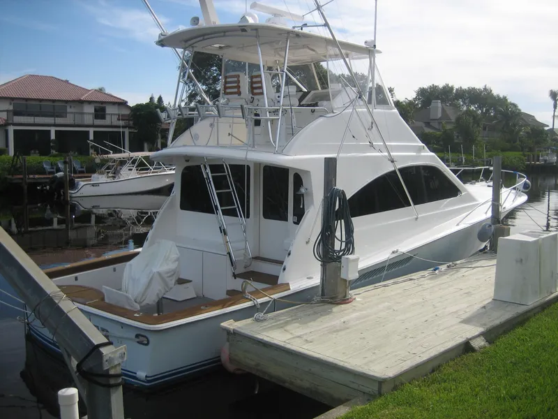 The Image of 2005 Ocean Yachts 50 Super Sport docked, showcasing sleek design and spacious deck. - 0