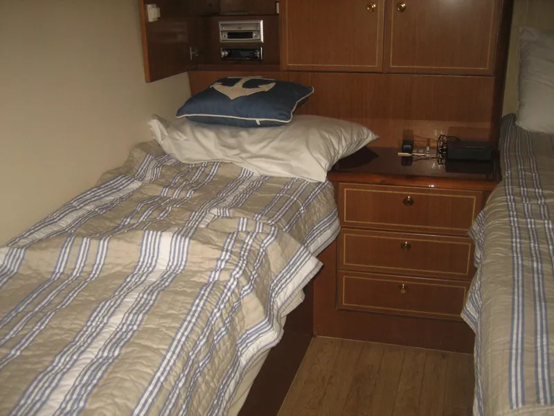 Slide: The Image of Twin beds in a 2005 Ocean Yachts 50 Super Sport cabin with striped bedding. - 10