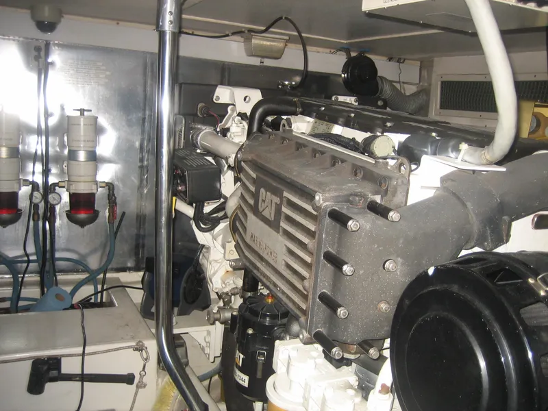 Slide: The Image of Engine room of 2005 Ocean Yachts 50 Super Sport, featuring a CAT marine engine. - 12
