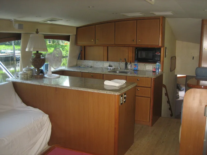 Slide: The Image of Interior of 2005 Ocean Yachts 50 Super Sport with kitchen and seating area. - 4