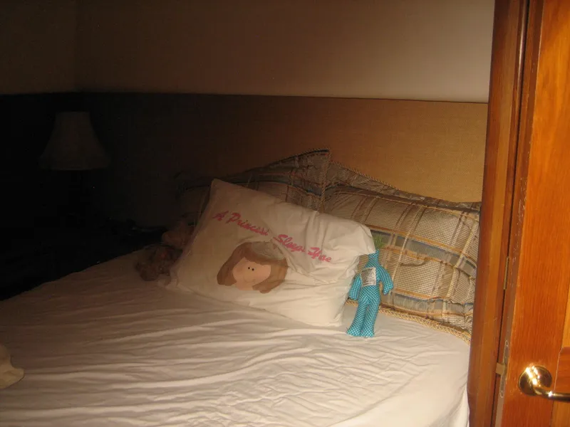 Slide: The Image of Cozy bedroom in 2005 Ocean Yachts 50 Super Sport with decorative pillows and soft lighting. - 8