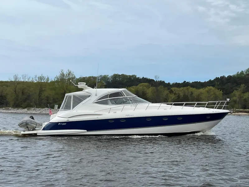 Slide: The Image of 2005 Cruisers Yachts 540 Express on a calm lake with trees in the background. - 0