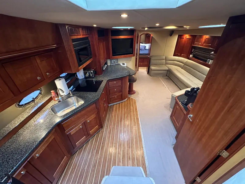 Slide: The Image of Luxurious interior of 2005 Cruisers Yachts 540 Express with wood cabinetry and modern amenities. - 17