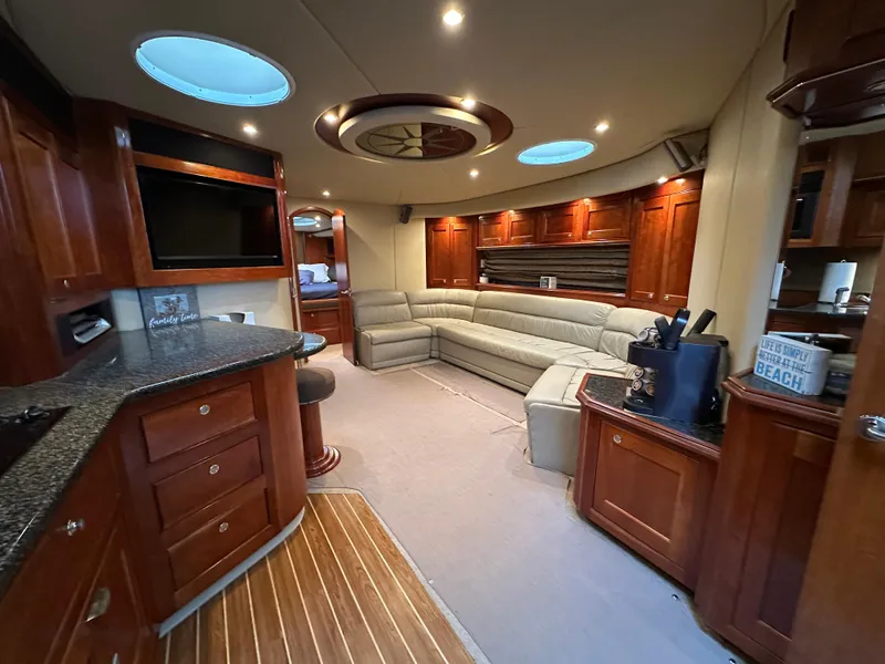 Slide: The Image of Luxurious 2005 Cruisers Yachts 540 Express interior with elegant wood finishes and plush seating. - 18