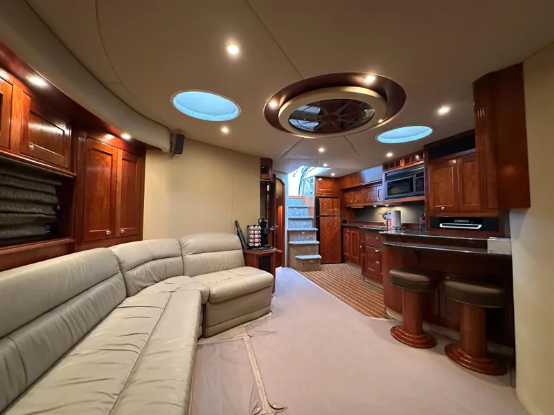 Slide: The Image of Luxurious interior of 2005 Cruisers Yachts 540 Express with elegant wood cabinetry and plush seating. - 23