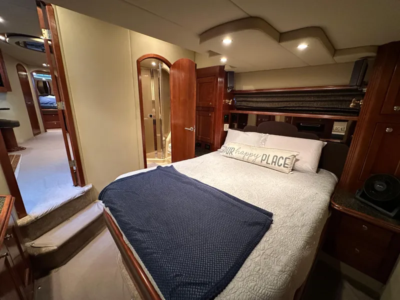 Slide: The Image of Luxurious bedroom interior of 2005 Cruisers Yachts 540 Express with cozy bedding. - 26