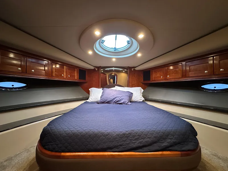 Slide: The Image of Luxurious 2005 Cruisers Yachts 540 Express cabin with elegant wood cabinetry and skylight. - 30