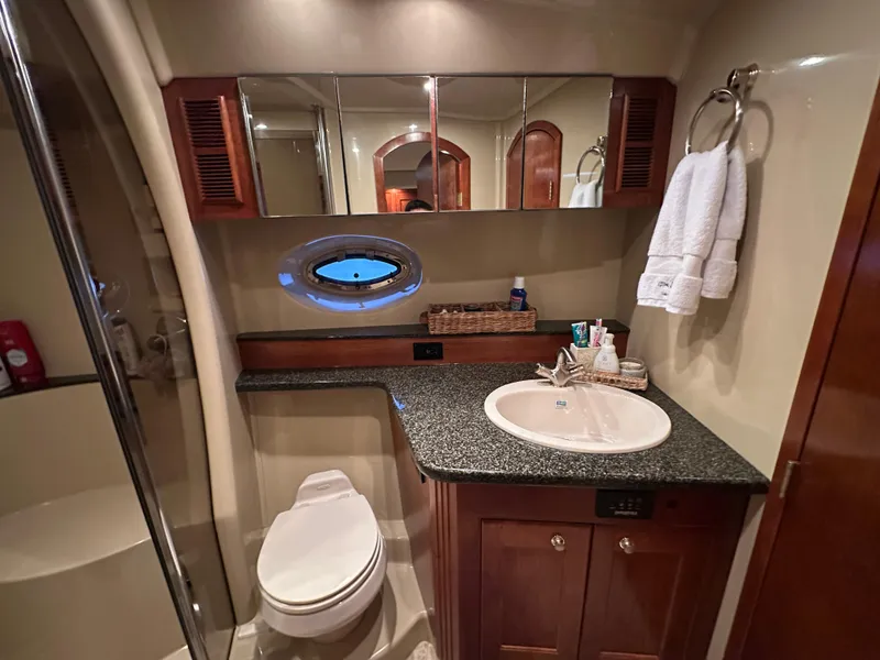 Slide: The Image of Luxurious 2005 Cruisers Yachts 540 Express bathroom with elegant fixtures and modern design. - 34
