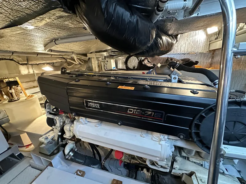 Slide: The Image of Engine room of 2005 Cruisers Yachts 540 Express, featuring a powerful diesel engine. - 36