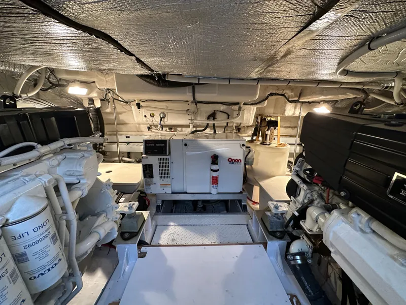 Slide: The Image of Engine room of 2005 Cruisers Yachts 540 Express, featuring mechanical equipment and wiring. - 37