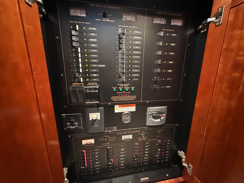 Slide: The Image of Electrical panel inside 2005 Cruisers Yachts 540 Express, featuring switches and circuit breakers. - 41