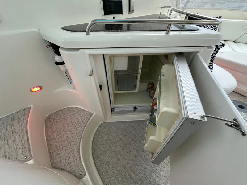 Slide: The Image of 2005 Cruisers Yachts 540 Express interior with open mini fridge and modern design. - 7