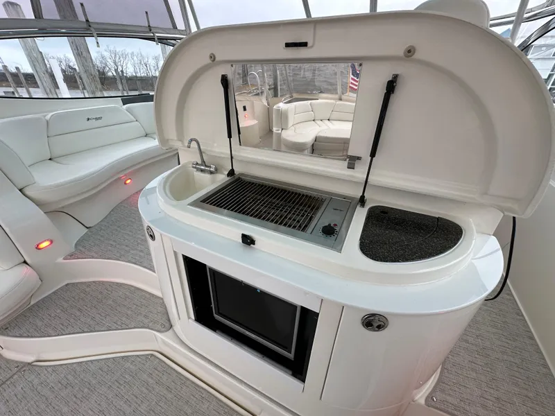 Slide: The Image of 2005 Cruisers Yachts 540 Express interior with kitchenette and seating area. - 8