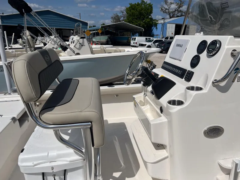 Slide: The Image of 2025 Key West 210 Bay Reef boat interior with steering console and seating. - 6