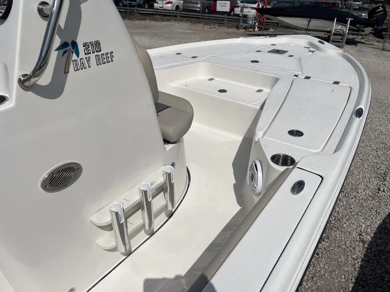 Slide: The Image of 2025 Key West 210 Bay Reef boat, white deck, rod holders, and seating area. - 7