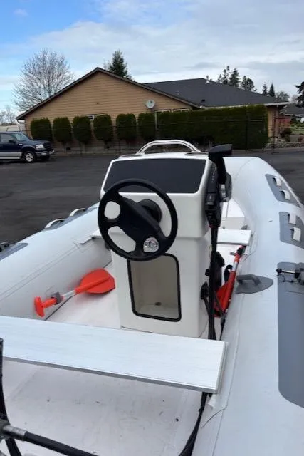 Slide: The Image of 2005 Meridian PILOTHOUSE boat with steering console and orange paddle, parked outdoors. - 12