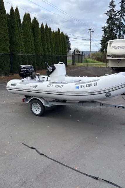 Slide: The Image of 2005 Meridian PILOTHOUSE inflatable boat on trailer, parked outdoors. - 13