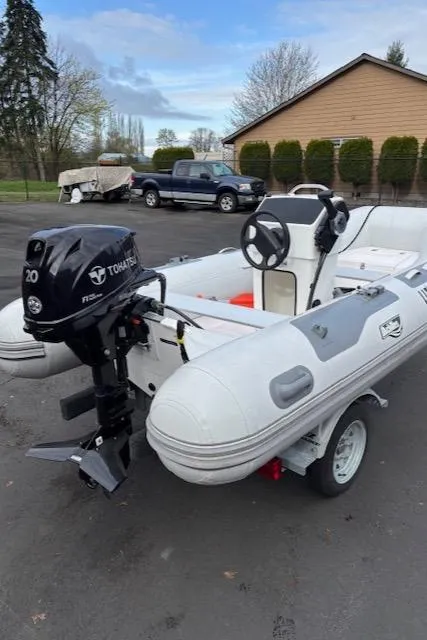 Slide: The Image of 2005 Meridian PILOTHOUSE inflatable boat with Tohatsu outboard motor on a trailer. - 14