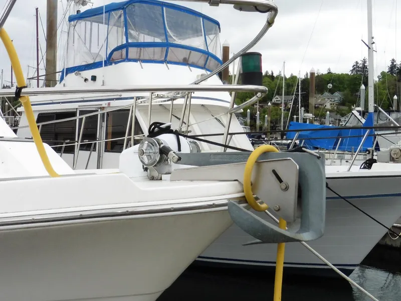 Slide: The Image of 2005 Meridian PILOTHOUSE yacht docked, featuring anchor and blue canopy. - 15