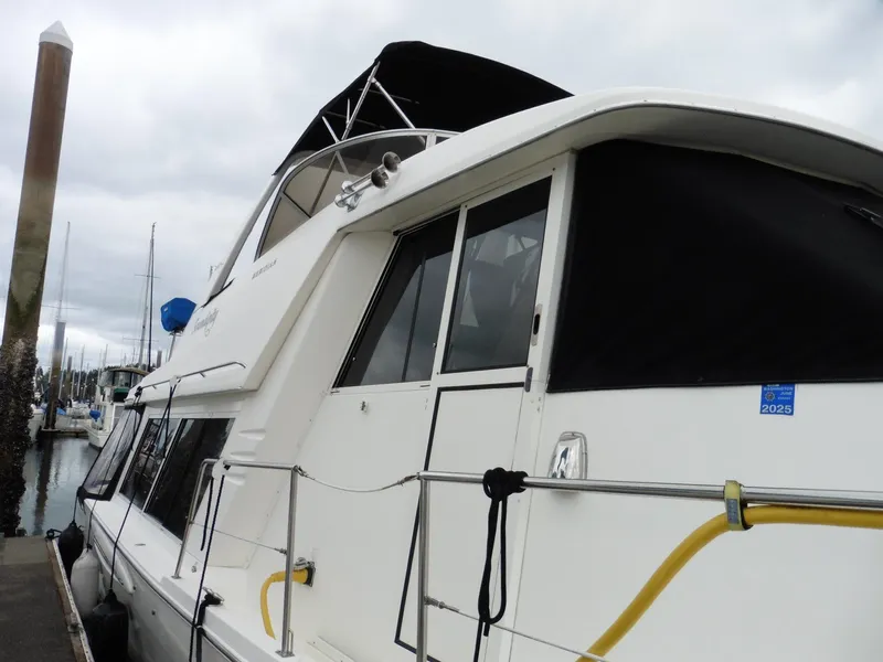 Slide: The Image of 2005 Meridian PILOTHOUSE yacht docked at marina, featuring sleek design and spacious cabin. - 16