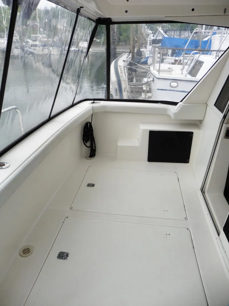 Slide: The Image of 2005 Meridian PILOTHOUSE boat interior with spacious deck and marina view. - 19