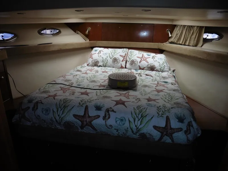 Slide: The Image of Luxurious 2005 Meridian PILOTHOUSE bedroom with nautical-themed bedding and cozy lighting. - 35