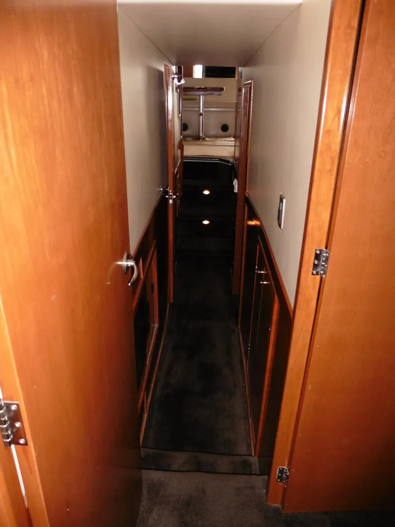 Slide: The Image of 2005 Meridian PILOTHOUSE yacht interior hallway with wooden doors and carpeted floor. - 39