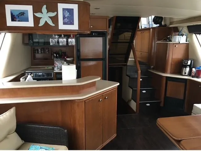 Slide: The Image of Luxurious 2005 Meridian PILOTHOUSE yacht interior with modern kitchen and elegant wood finishes. - 4