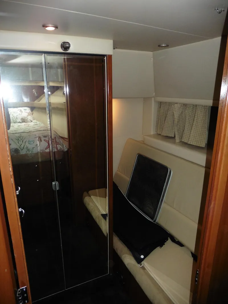 Slide: The Image of 2005 Meridian PILOTHOUSE interior with seating, glass doors, and cozy cabin space. - 40