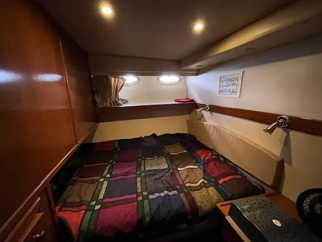 Slide: The Image of Cozy bedroom in 2005 Meridian PILOTHOUSE yacht with colorful bedding and warm lighting. - 7