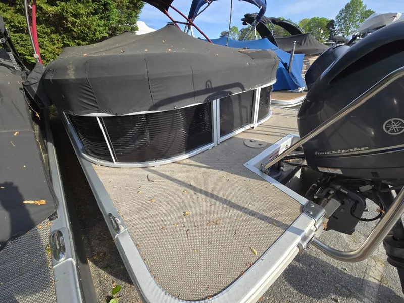 Slide: The Image of 2015 Bennington 24 SSRX30 pontoon boat with Yamaha outboard motor, covered and docked. - 12