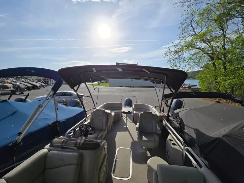 Slide: The Image of 2015 Bennington 24 SSRX30 pontoon boat docked under sunny sky. - 14
