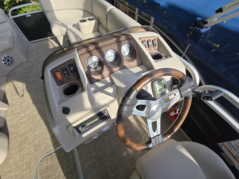 Slide: The Image of 2015 Bennington 24 SSRX30 boat interior with steering wheel and control panel. - 15