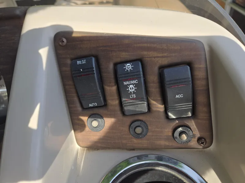 Slide: The Image of Control panel of a 2015 Bennington 24 SSRX30 boat with switches for bilge, navigation lights, and accessories. - 19