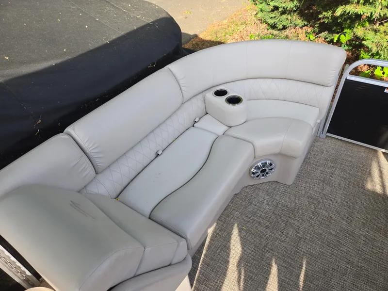 Slide: The Image of Luxurious seating on a 2015 Bennington 24 SSRX30 pontoon boat with cup holders and speaker. - 26