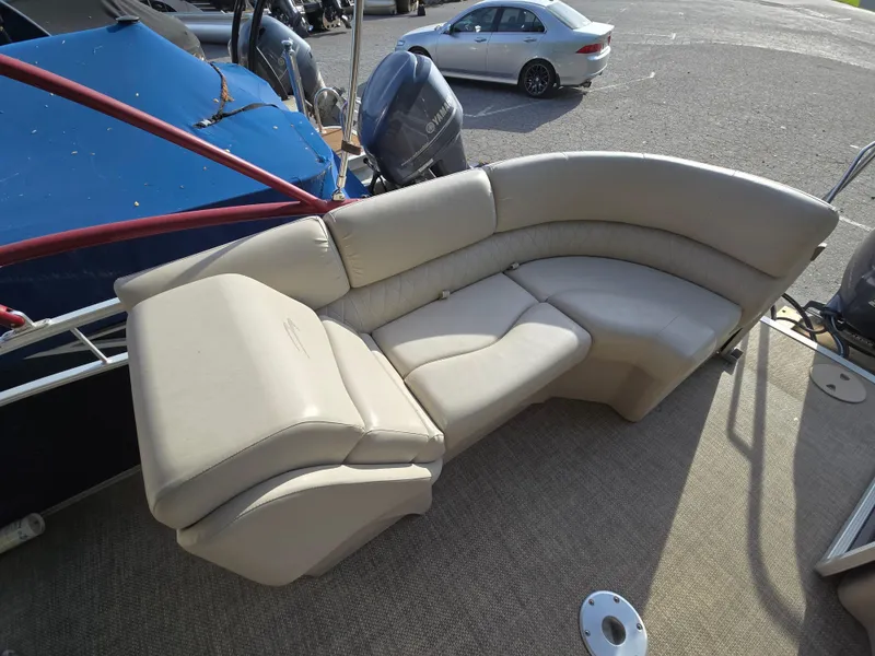 Slide: The Image of 2015 Bennington 24 SSRX30 boat with beige seating and carpeted deck. - 30
