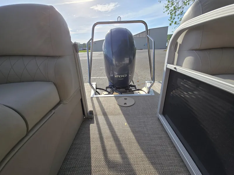 Slide: The Image of 2015 Bennington 24 SSRX30 pontoon boat interior with Yamaha 200 engine, sunny day. - 31