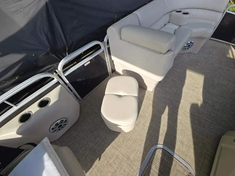 Slide: The Image of 2015 Bennington 24 SSRX30 pontoon boat interior with beige seating and carpet. - 35
