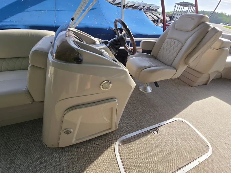 Slide: The Image of Interior of 2015 Bennington 24 SSRX30 boat with beige seating and steering console. - 36
