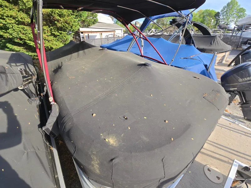Slide: The Image of Covered 2015 Bennington 24 SSRX30 boat with protective tarp in a marina setting. - 39