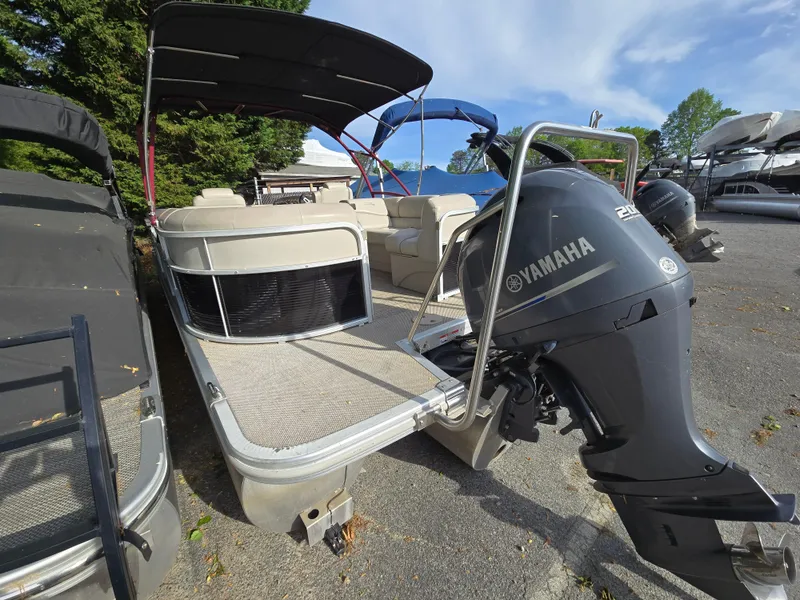 Slide: The Image of 2015 Bennington 24 SSRX30 pontoon boat with Yamaha outboard motor, parked outdoors. - 7