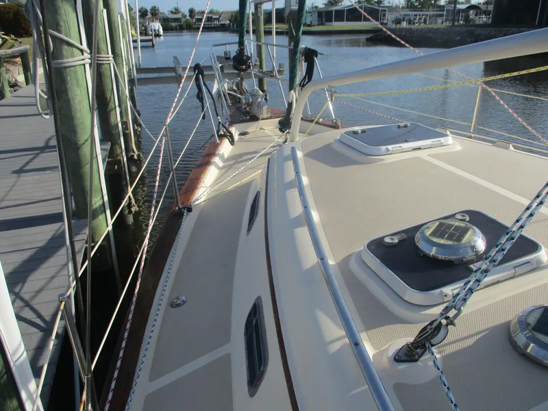 Slide: The Image of 1999 Island Packet 380 sailboat docked, showcasing deck and rigging details. - 12