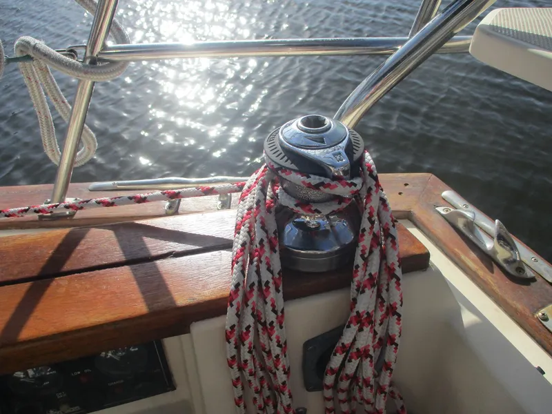 Slide: The Image of Sailboat winch with ropes on 1999 Island Packet 380, reflecting sunlight on water. - 19