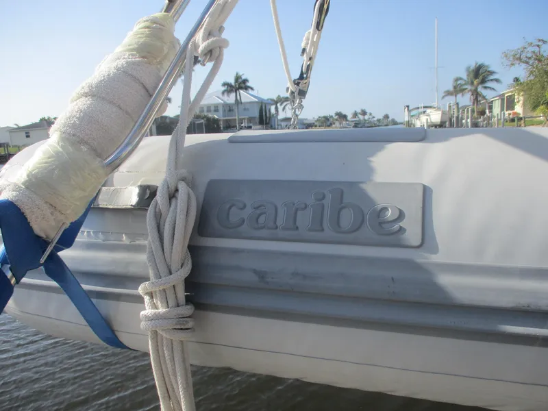 Slide: The Image of Inflatable Caribe dinghy attached to a 1999 Island Packet 380 sailboat. - 25